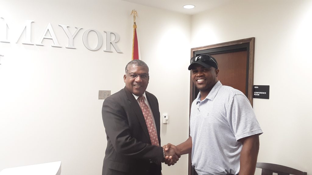 Bessemer Mayor Kenneth Gulley (left) meets with new Bessemer City High School head football coach Andrew Zow.