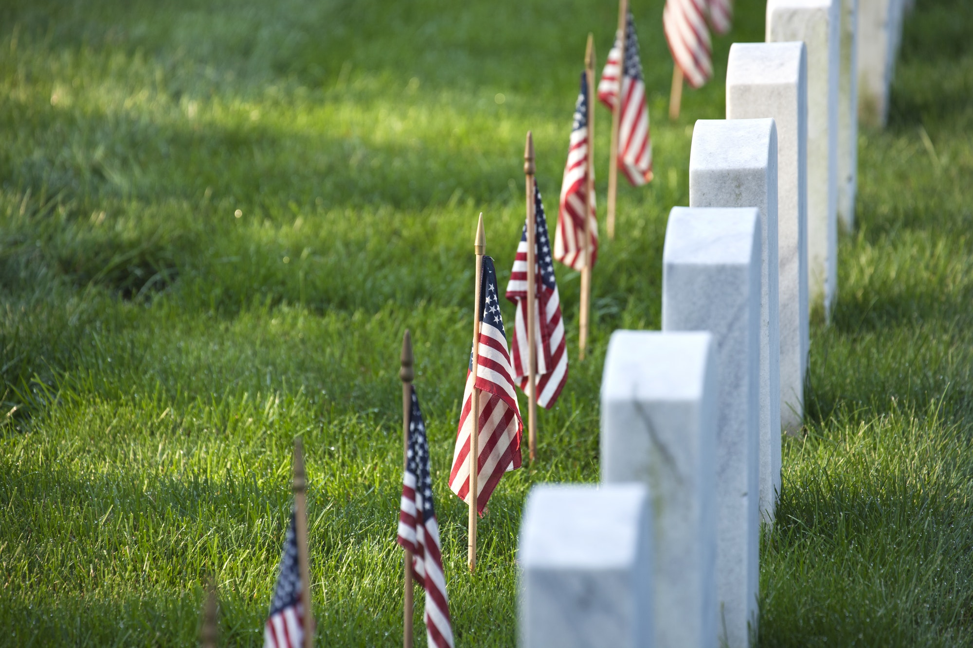 American flags in front of tombstones at Arlington National Cemetery for Memorial Day